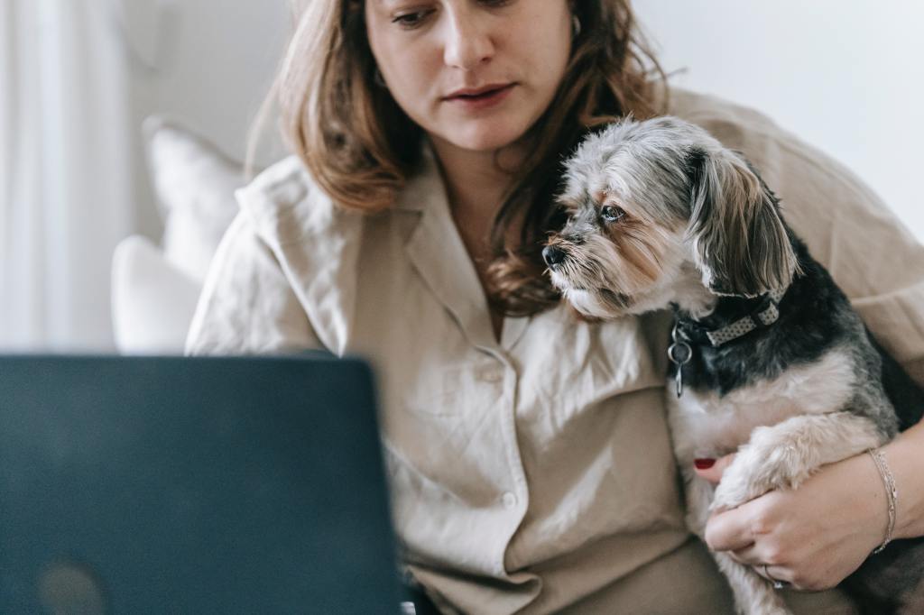 woman-working-on-laptop-with-dog-near