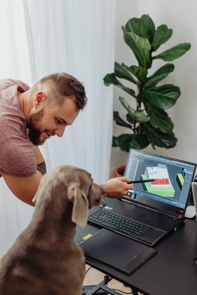 hot-of-a-man-giving-instruction-on-computer-screen-to-a-dog
